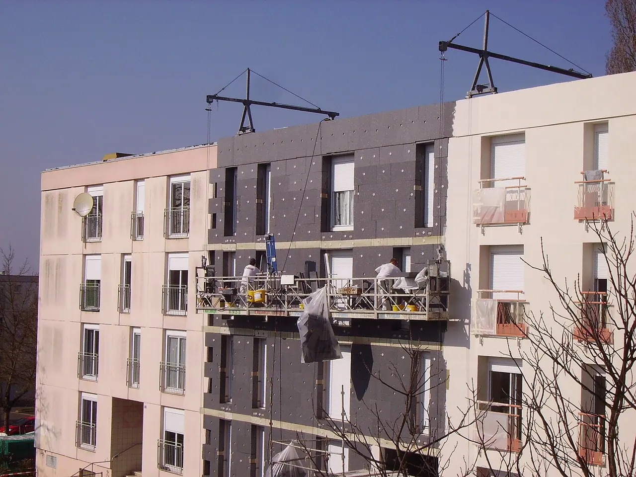 Insulation boards being installed on a facade (EIFS)