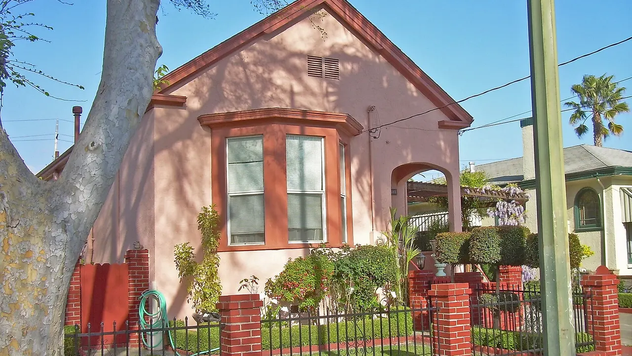 Pink stucco house with bay windows in California