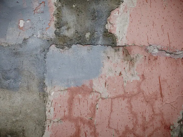 Peeling and weathered stucco finish