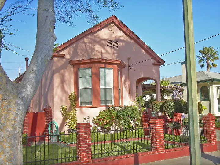 Pink stucco house with bay windows in California