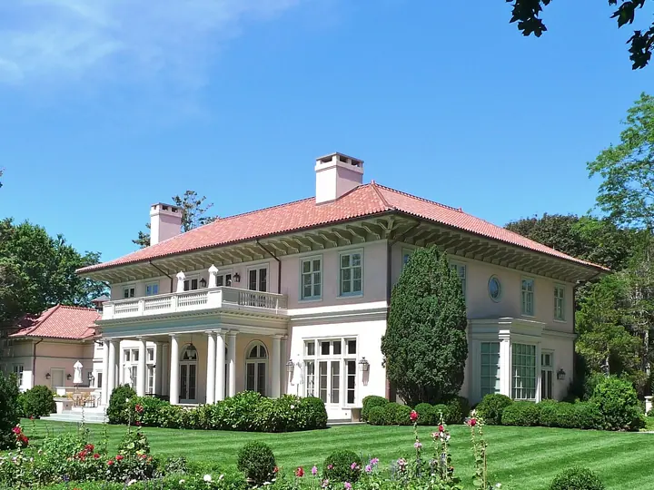 Smooth white stucco facade with arched windows