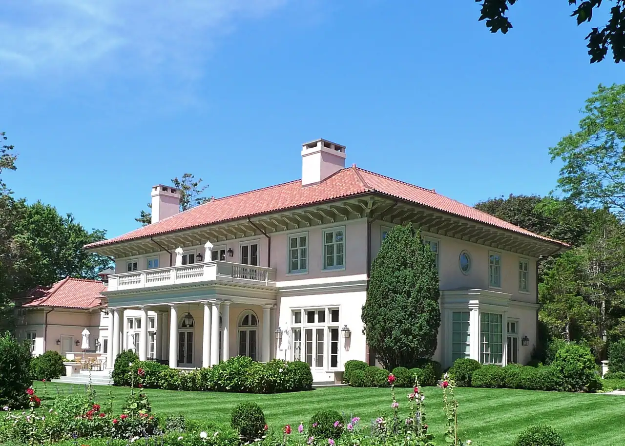 Smooth white stucco facade with arched windows